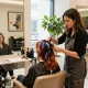 Hair colourist Dubai styling a client in an upscale salon environment with vibrant colors.