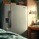 Showcase a dorm room fridge filled with snacks and beverages in a vibrant college setting.