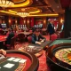 Experience the thrill of high-stakes gambling at https://kjc.uk.com/ with vibrant casino visuals showing poker tables and roulette wheels.
