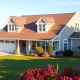 Cape Cod homes featuring classic architecture and a beautiful attached garage in a coastal setting.
