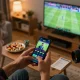 Person placing bets on CAKHIATV in an exciting sports betting environment with a smartphone.