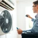 Air Conditioning Repair Tampa professional technician servicing a unit in a bright home.