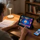 Person using tablet for online gaming on thabete, showing betting strategies and casino game interface.