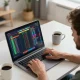 Player excitedly engaging in oxbet online sports betting from a modern home office setup, showcasing strategy and thrill