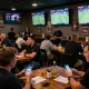 Experiencing excitement while placing bets on net88 in a lively sports betting bar atmosphere