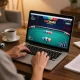 Person playing poker on XOCDIA88 online gaming platform showcasing vibrant gameplay and strategic engagement.