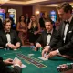 Engaged players strategizing at a high-stakes blackjack table featuring DA88 chips.
