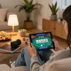 Player engaging with poker game on tablet through 88VIN in a cozy home setting, with strategic notes visible