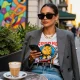 Vibrant fashion blog scene showcasing stylish outfit in urban café setting during golden hour.