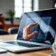 Interact with call history checker software on a laptop in a bright, modern workspace.
