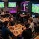 Socolive sports betting scene with friends enjoying live football match excitement and strategic discussions.