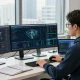 Professional using proxies on multiple screens in a modern tech workspace