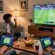 Friends enjoying SBOBET sports betting experience in a lively living room.