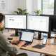 Professional workspace with WPS Office applications on monitors and a focused individual working in a bright office environment.