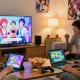 Group of friends playing hentaigames in a cozy living room, engaging with devices and sharing laughs.