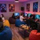 Dynamic gaming lounge with friends enjoying nsfw games, colorful LED lights, and immersive atmosphere