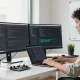 vds satın al developer coding in a modern workspace with dual monitors and programming tools