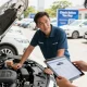 Car history report review during a dealership inspection, highlighting the importance of thorough vehicle checks.